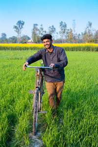 Portrait of young man standing on field