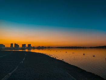 Scenic view of road against blue sky during sunset