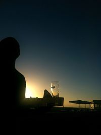 Low angle view of silhouette built structures at sunset