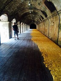 Woman walking in tunnel