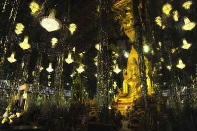 Low angle view of illuminated lanterns hanging outside building at night