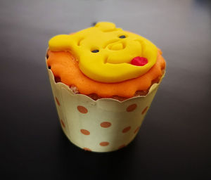 Close-up of cupcakes on table against black background