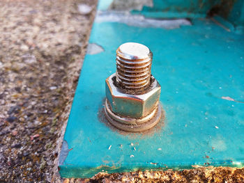 High angle view of metallic container on rusty metal