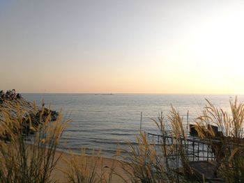 Scenic view of sea against clear sky during sunset