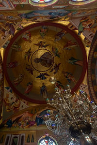 Low angle view of sculptures on ceiling at temple