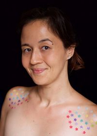 Portrait of young woman against black background