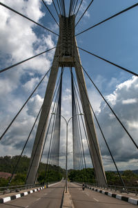 Low angle view of suspension bridge against sky