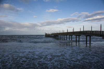 Pier over sea against sky