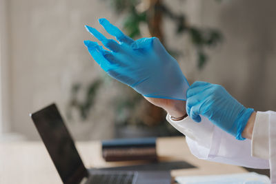 Cropped hand of woman using mobile phone