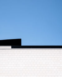 Low angle view of building against clear blue sky