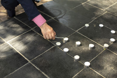Low section of man standing on tiled floor