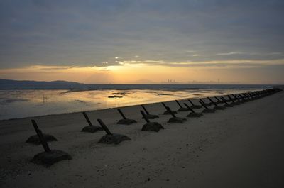 Scenic view of beach against sky during sunset