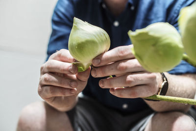 Midsection of woman holding fruit