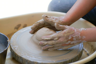 Midsection of person preparing food in mud