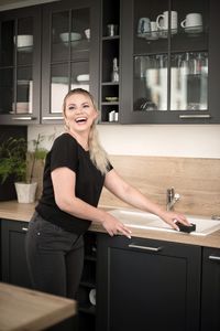 Portrait of a smiling young woman at home