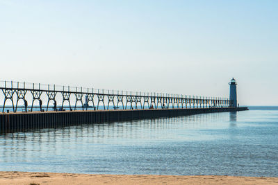 Pier over sea against clear sky