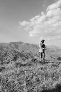 Man standing on field against sky