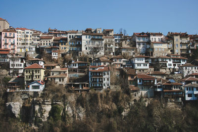 Buildings in city against clear sky