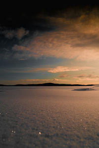 View of salt flat against sky during sunset