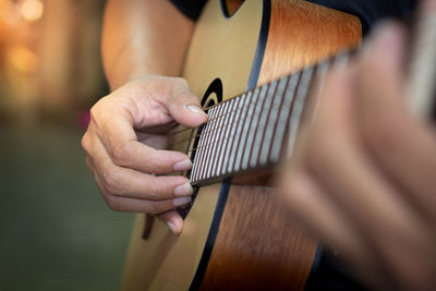Close up a musician playing guitar and singing