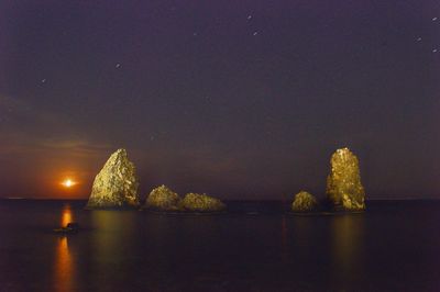Scenic view of sea against sky at night