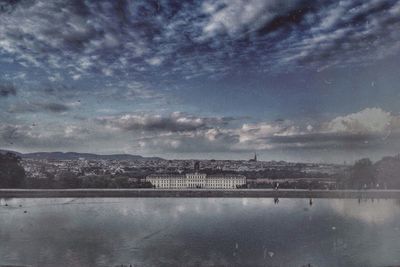 Scenic view of river against cloudy sky