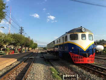 Train at railroad station against sky