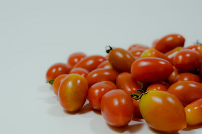 Close-up of cherry tomatoes over white background