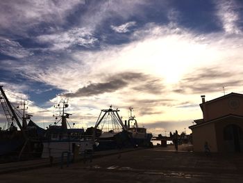Silhouette of buildings against cloudy sky