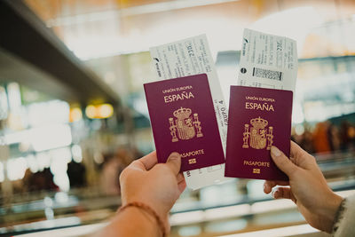 Travelers clutching passport and ticket at the airport