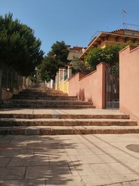 Footpath amidst buildings against sky