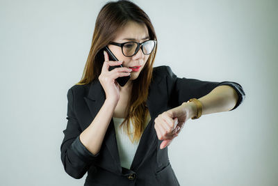 Portrait of woman standing against white background