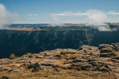 Fortaleza canyon with steep rocky cliffs and mist coming up. near cambara do sul. brazil.