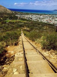 View of road leading towards blue sky