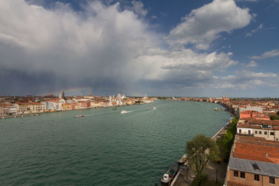 High angle view of venice townscape  and giudecca canal against sky, with rainbow