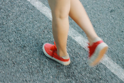 Low section of woman standing on street