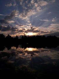 Scenic shot of calm lake at sunset