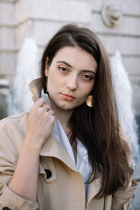 Portrait of beautiful young woman standing outdoors