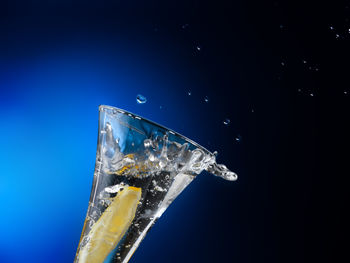 Close-up of frozen glass against black background