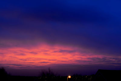 Low angle view of silhouette landscape against sky at sunset