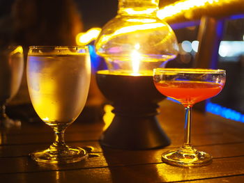 Close-up of wine glasses on table