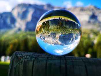 Close-up of crystal ball on wooden surface