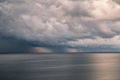 Scenic view of sea against stormy sky