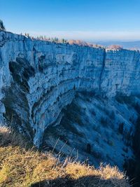 Scenic view of rock formations against blue sky