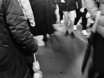 Low section of man standing on tiled floor