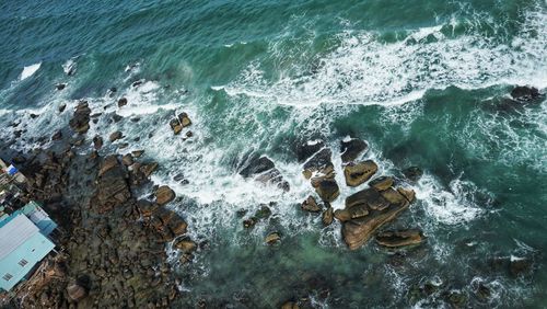 High angle view of rocks in sea