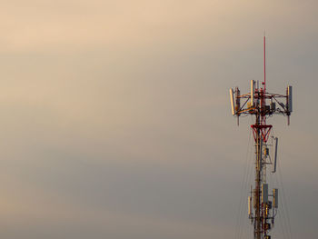 Low angle view of communications tower against sky