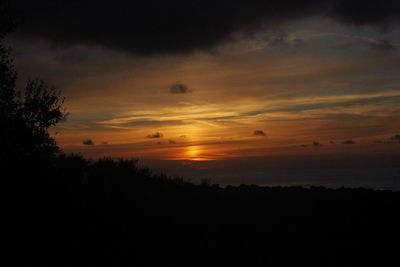 Scenic view of silhouette landscape against romantic sky at sunset