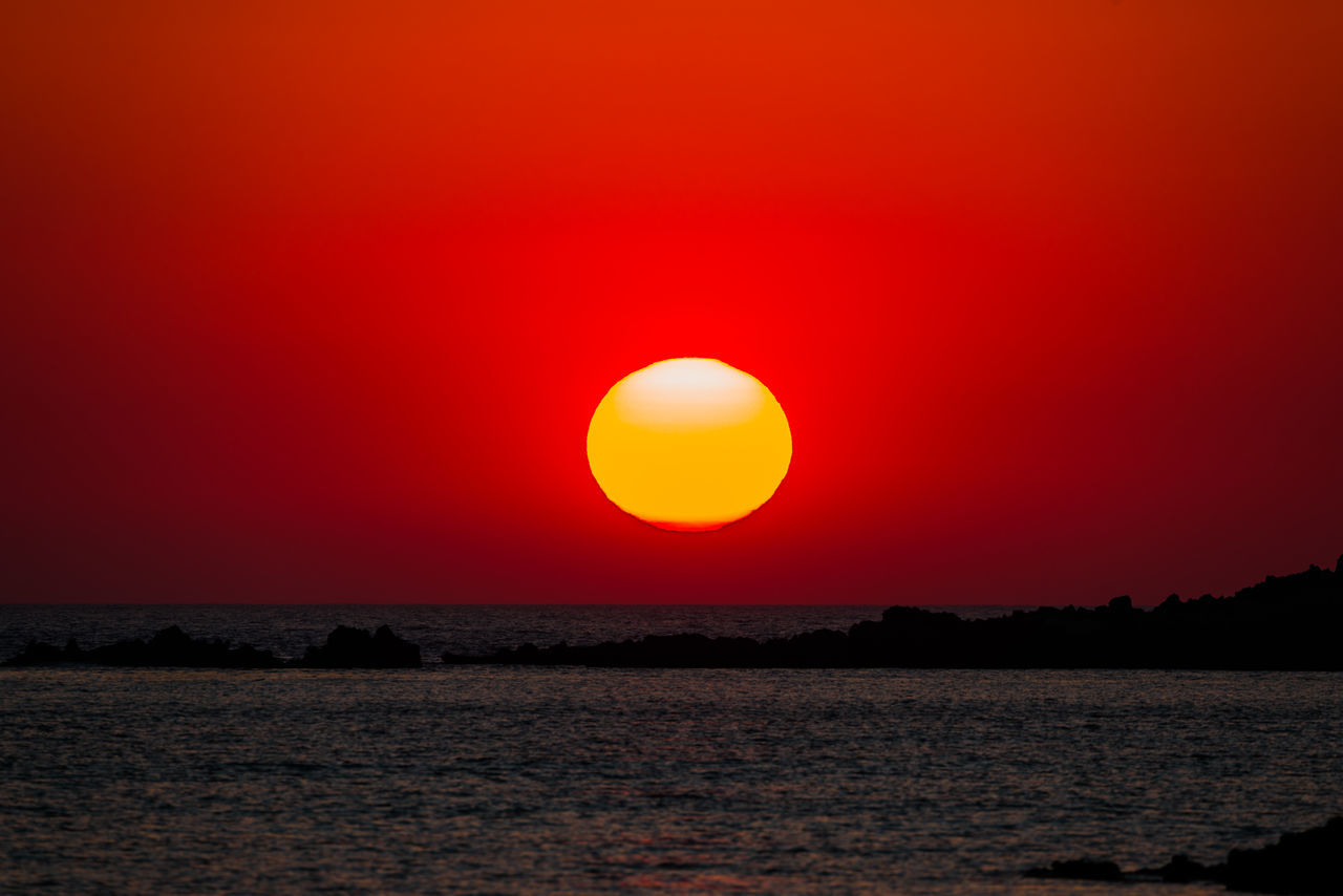 SCENIC VIEW OF SEA AGAINST ORANGE SKY