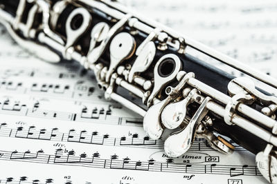 Close-up of woodwind instrument on sheet music